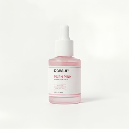 Pink serum bottle with white cap on a light gray background