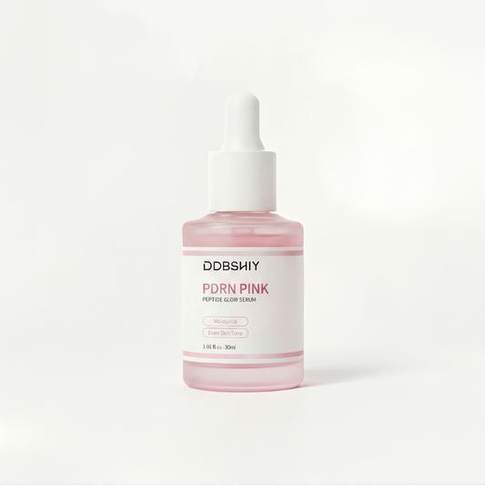 Pink serum bottle with white cap on a light gray background